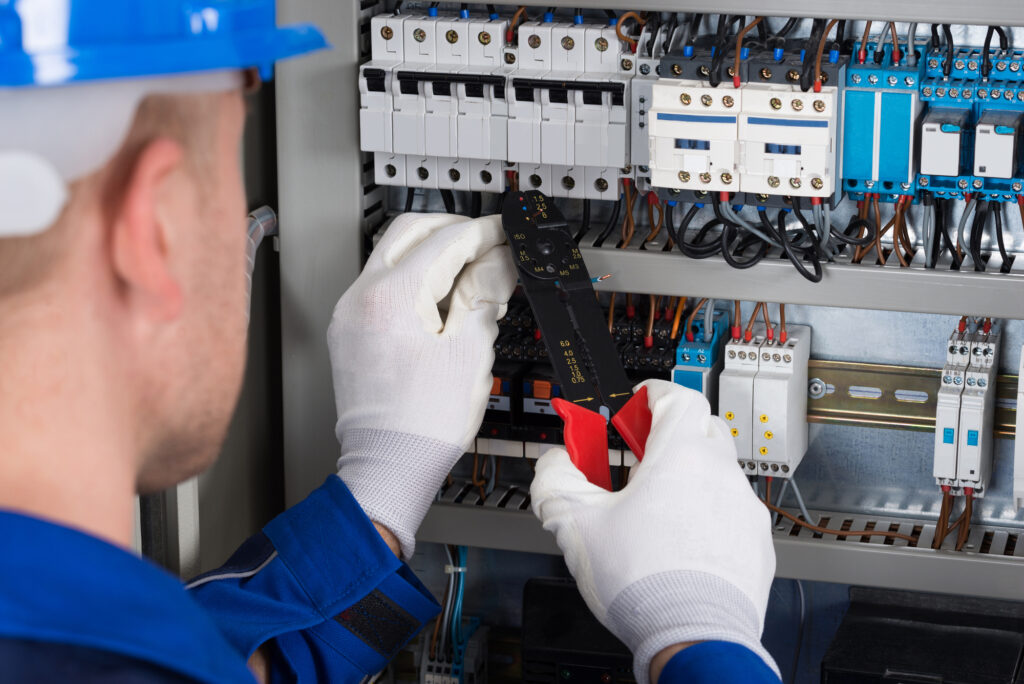 Electrician in Jupiter, FL working on breaker box