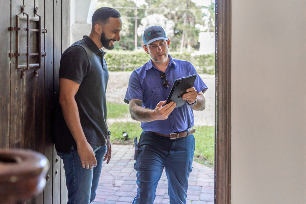 Electrician going over a surge protection installation plan with a homeowner in Stuart, FL